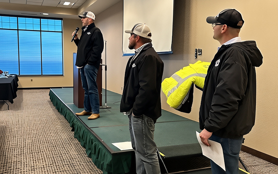 Three men at a conference.